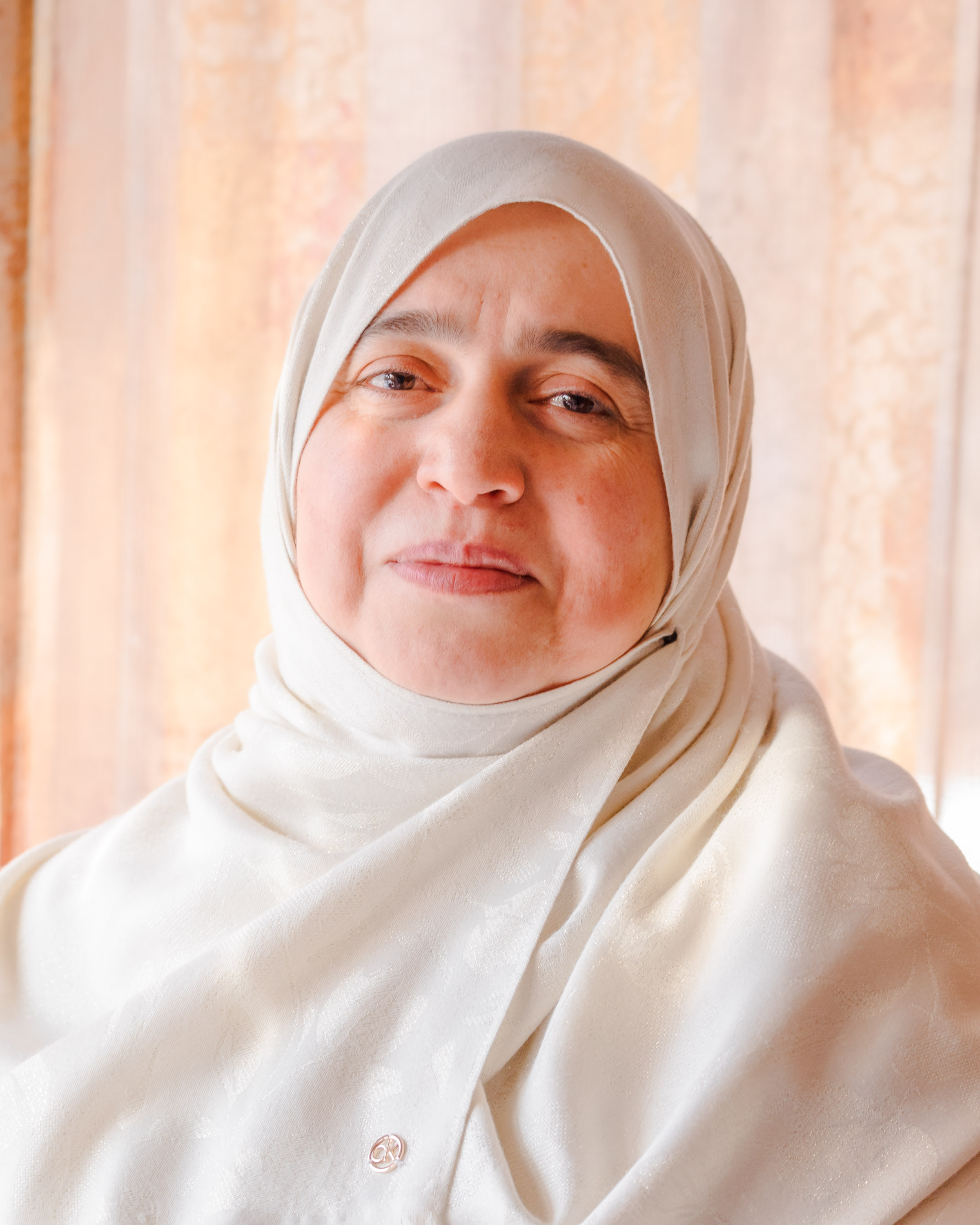 A headshot of Dr. Nabila Hijazi wearing white.