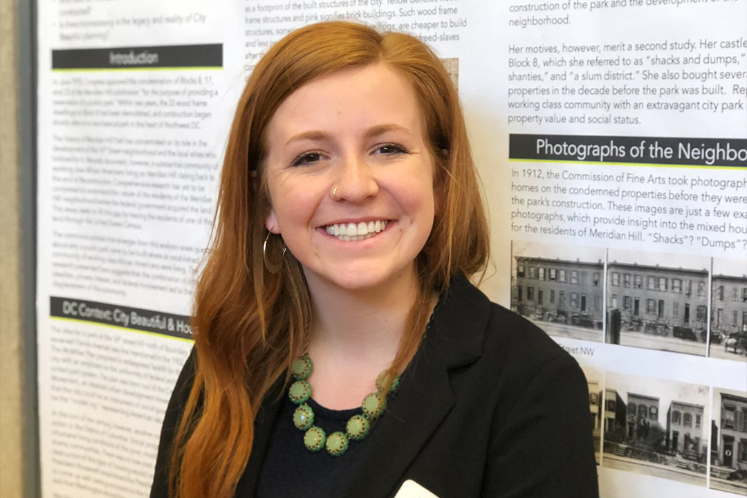 Lydia Francis in front of her poster