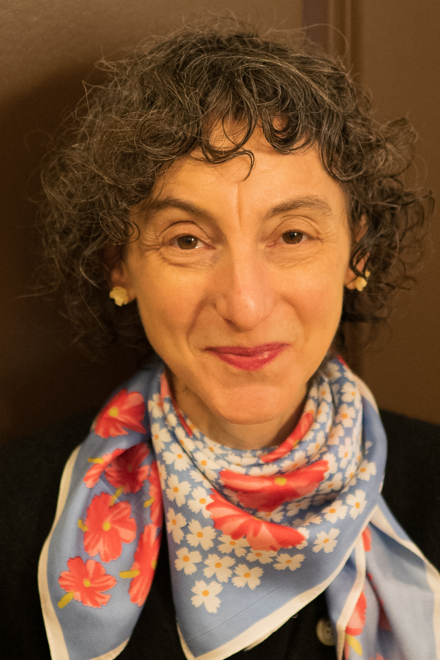 Headshot of Sandie Friedman smiling with a colorful scarf.