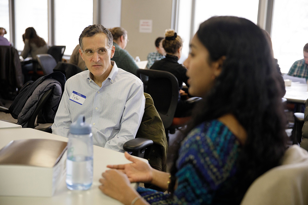 A student talk with professor Tyler Anbinder at the Writing in Discipline event