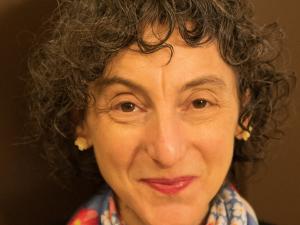Headshot of Sandie Friedman smiling with a colorful scarf.