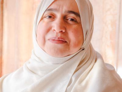 A headshot of Dr. Nabila Hijazi wearing white.