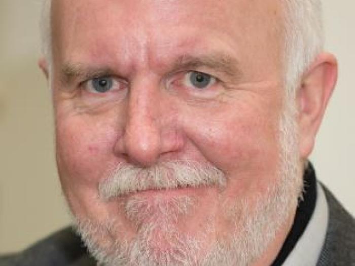 Headshot of Michael Svoboda in a brown jacket.